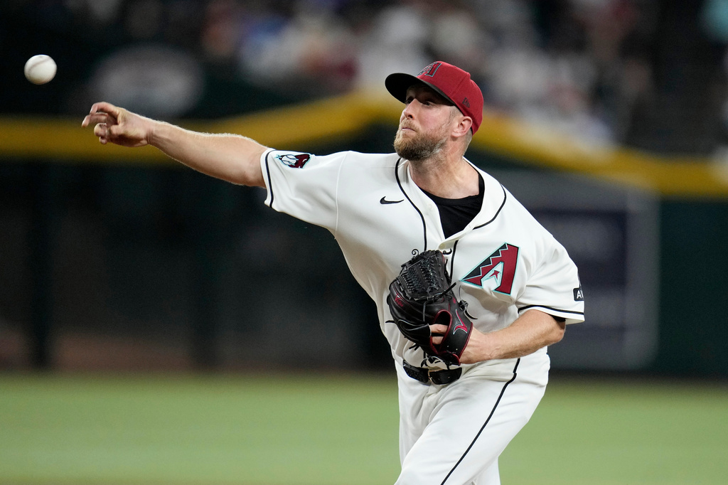 Arizona Diamondbacks starting pitcher Merrill Kelly throws against the Chicago Cubs during the first inning of a baseball game, Monday, Aug. 24, 2026, in Phoenix. (AP Photo/Ross D. Franklin)