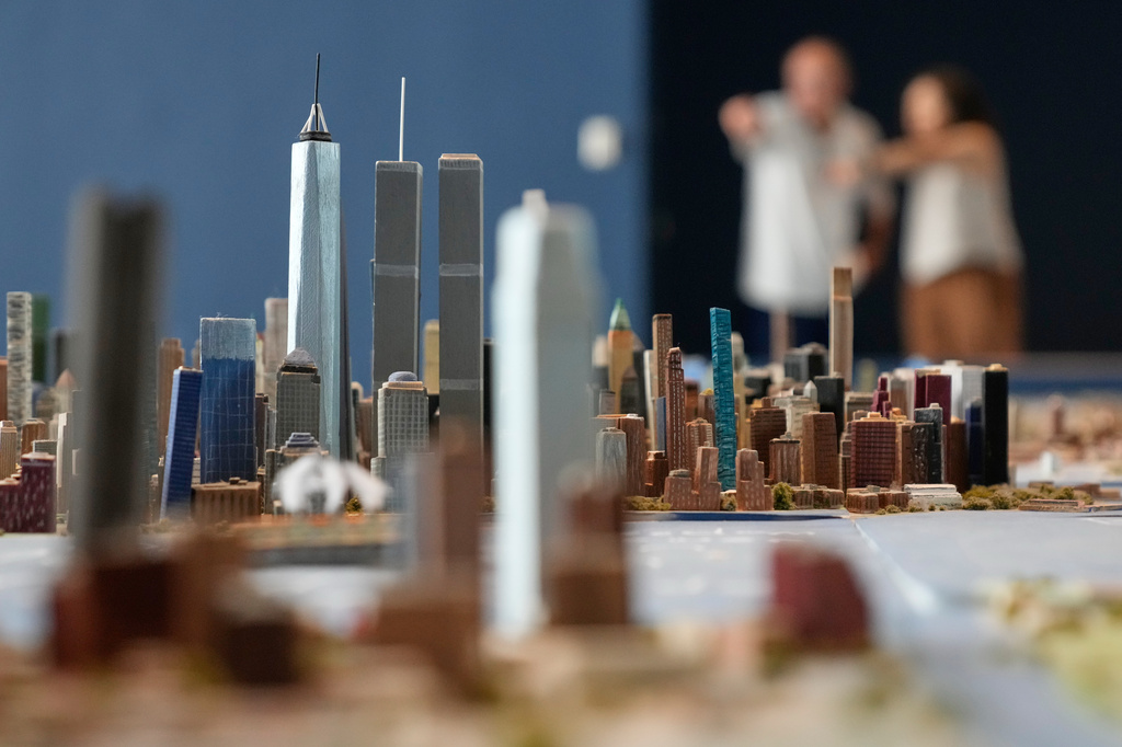 Lower Manhattan, featuring both the One World Trade and the Twin Towers, is seen on a large model of the New York City, made by Joe Macken, at the Museum of the City of New York in New York, Monday, Sept. 14, 2026. (AP Photo/Seth Wenig)