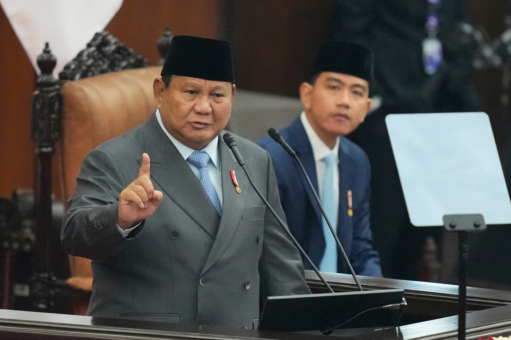 Indonesian President Prabowo Subianto, left, delivers his annual State of the Nation Address as Indonesian Vice President Gibran Rakabuming Raka listens ahead of the country's Independence Day at the parliament building in Jakarta, Indonesia, Friday, Aug. 14, 2026. (AP Photo/Dita Alangkara)
