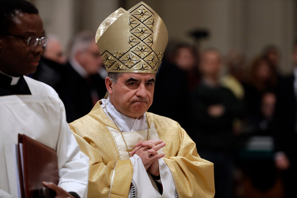 FILE - Mons. Angelo Becciu presides over an eucharistic liturgy at the St. John Lateran Basilica in Rome, Feb. 9, 2017. (AP Photo/Gregorio Borgia, File)