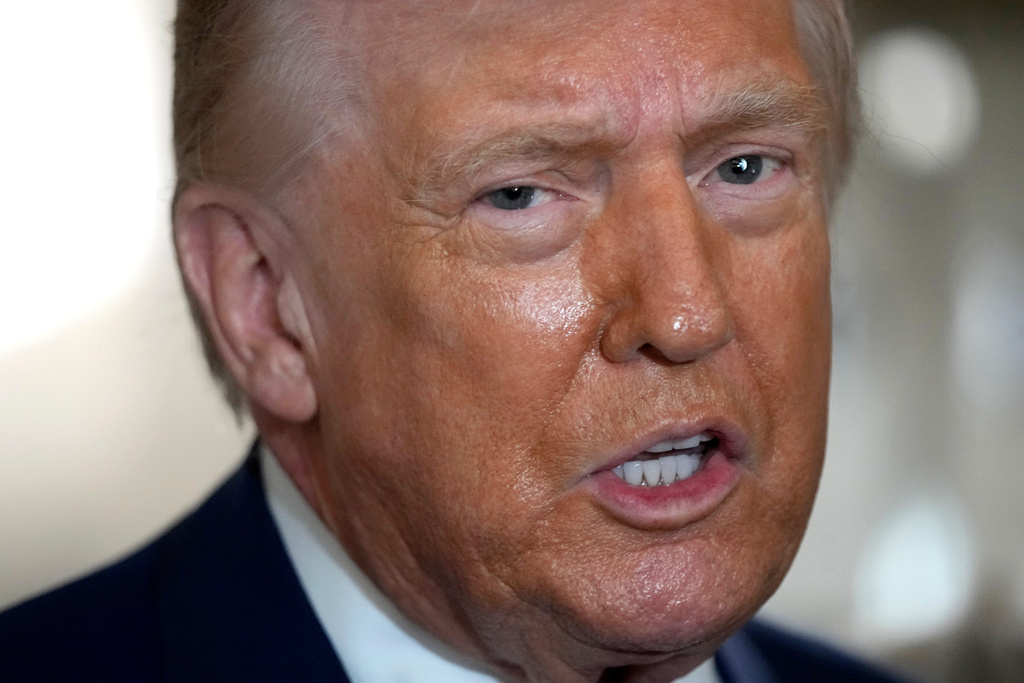 President Donald Trump speaks to reporters aboard Air Force One shortly before takeoff, Thursday, Feb. 19, 2026, at Joint Base Andrews, Md. (AP Photo/Mark Schiefelbein)