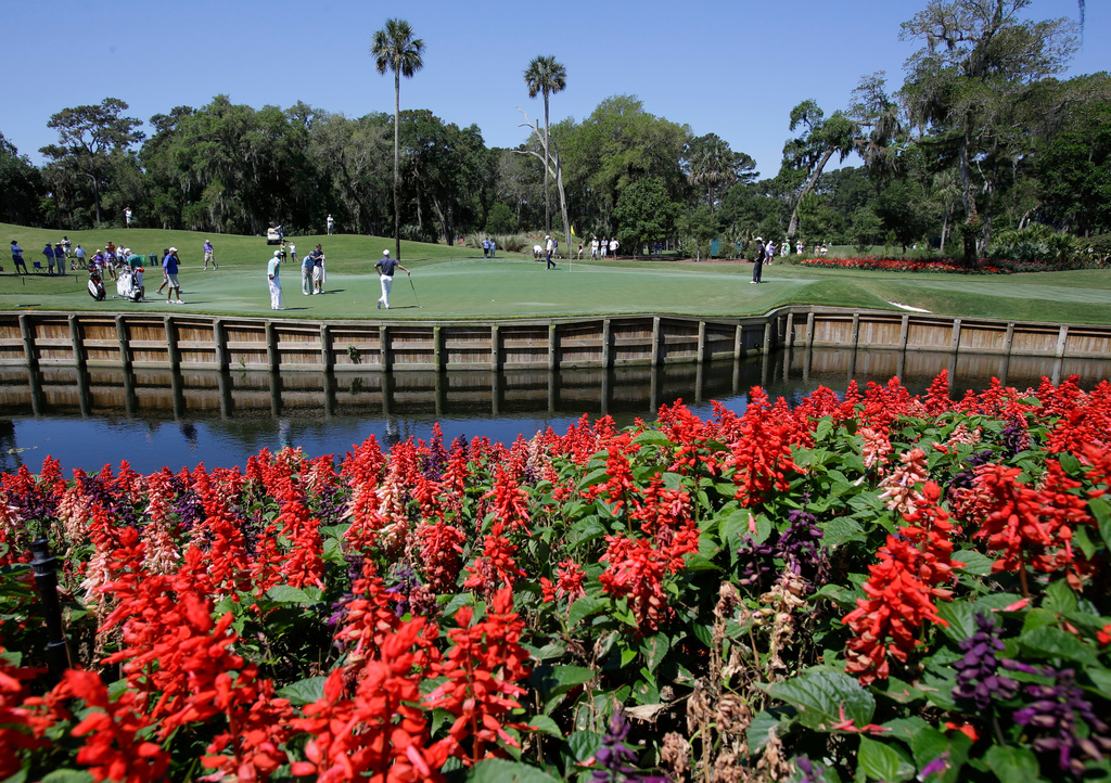 FILE -Players work on their putting on the 13th green during a practice round for The Players championship golf tournament at TPC Sawgrass in Ponte Vedra Beach, Fla., May 7, 2014. (AP Photo/John Raoux, File)