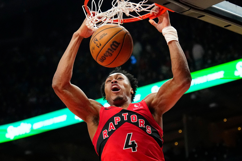 Toronto Raptors forward Scottie Barnes (4) slam dunks the ball during first half NBA basketball action against the Brooklyn Nets, in Toronto, Sunday, April 12, 2026. (Frank Gunn/The Canadian Press via AP)