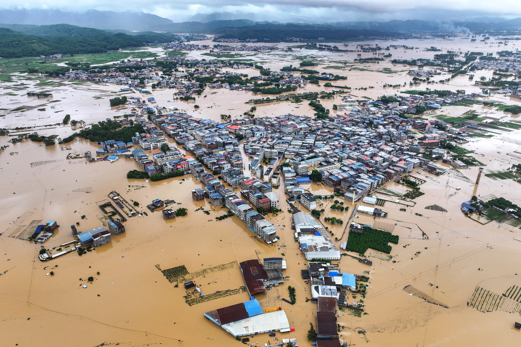 This photo released by Xinhua News Agency, shows a view of flooded downstream areas of the Liulan Reservoir after it was breached due to heavy rains in Hengzhou, Nanning City, south China's Guangxi Zhuang Autonomous Region on Monday, July 6, 2026. (Cao Yiming/Xinhua via AP)