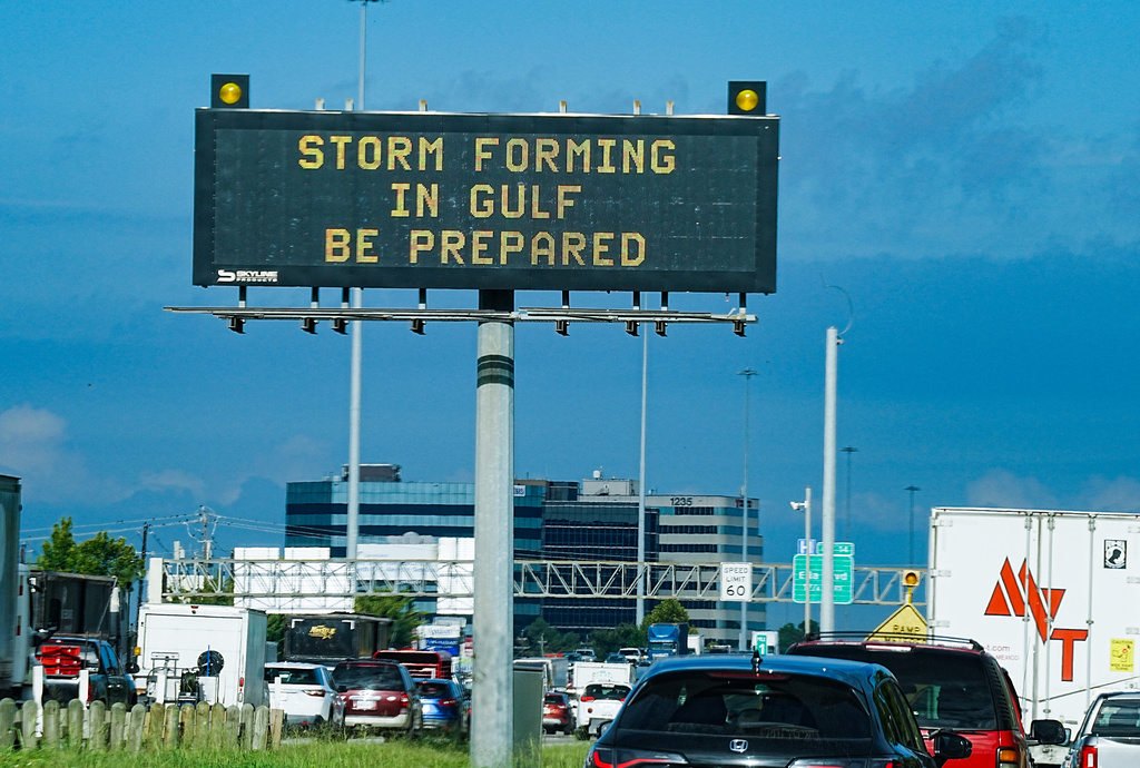 Motorists drive by Texas Department of Transportation signs on I-610 as Tropical Storm Edouard approaches in Houston, Tuesday, Sept. 1, 2026. (Elizabeth Conley/Houston Chronicle via AP)