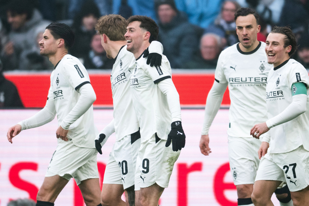 Mönchengladbach's Joe Scally, center, celebrates scoring with teammates during the Bundesliga soccer match between Borussia Mönchengladbach - FC Augsburg in Mönchengladbach, Germany, Sunday Jan. 11, 2026. (Marius Becker/dpa via AP)