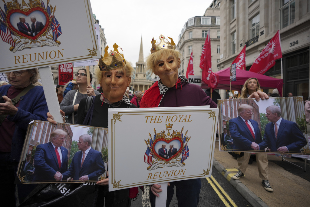 Protesters wear royal costumes during a demonstration of the Stop Trump Coalition group against President Donald Trump's state visit in London, Wednesday, Sept. 17, 2025.(AP Photo/Kin Cheung)