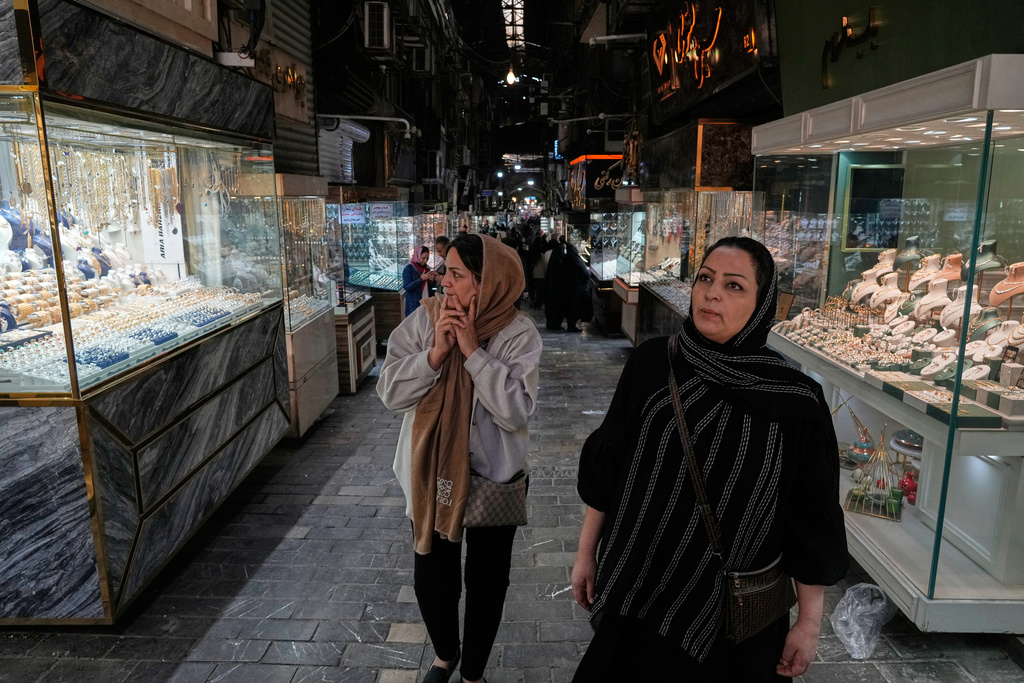 Women walk at a gold market in Tehran's Grand Bazaar, Iran, Saturday, Nov. 29, 2025. (AP Photo/Vahid Salemi)