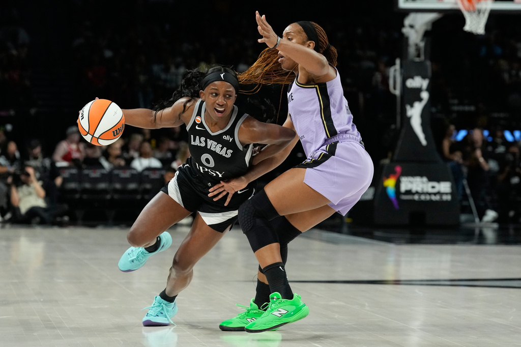 Las Vegas Aces guard Jackie Young (0) drives against Golden State Valkyries forward Kayla Thornton (5) during the second half of a WNBA basketball game Sunday, June 21, 2026, in Las Vegas. (AP Photo/John Locher)