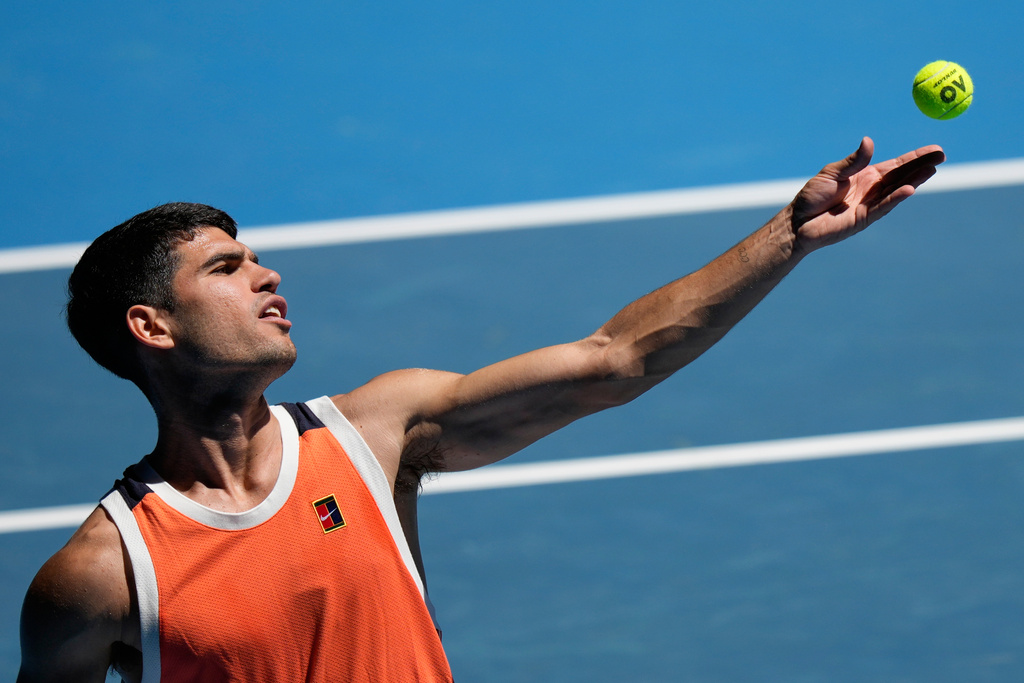 Carlos Alcaraz of Spain serves during a practice session ahead of the Australian Open tennis championship in Melbourne, Australia, Saturday, Jan. 17, 2026. (AP Photo/Aaron Favila)