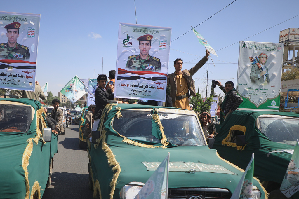 Pickup trucks travel in a mass funeral procession for Houthi officers and other military personnel in Sanaa, Yemen, Wednesday, Sept. 16, 2026. (AP Photo)