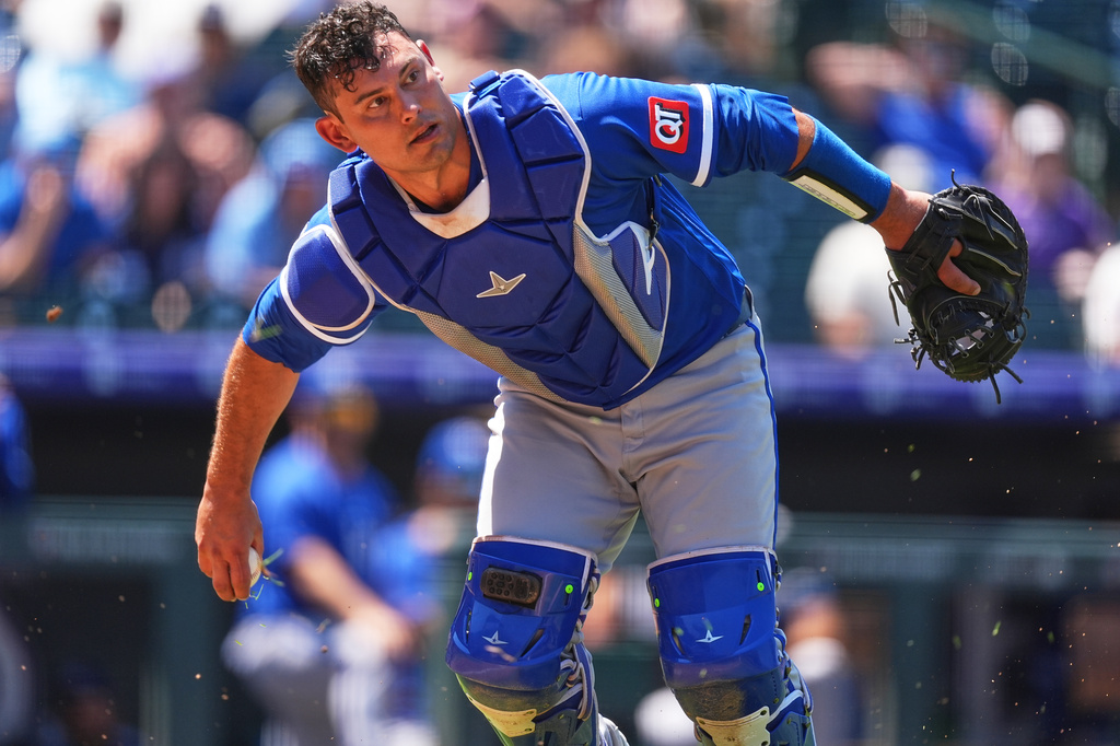 Kansas City Royals catcher Luke Maile throws to first base to put out Colorado Rockies' Willi Castro in the third inning of a baseball game Sunday, Aug. 2, 2026, in Denver. (AP Photo/David Zalubowski)