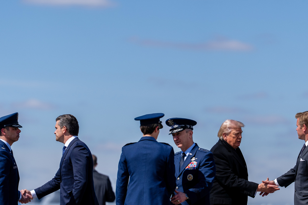 President Donald Trump arrives with Defense Secretary Pete Hegseth, second from left, and Chairman of the Joint Chiefs of Staff Gen. Dan Caine on Air Force One, Wednesday, March 18, 2026, at Dover Air Force Base, Del., to attend the casualty return for the six crew members of an Air Force refueling aircraft who died when their plane crashed in western Iraq while supporting operations against Iran. (AP Photo/Julia Demaree Nikhinson)