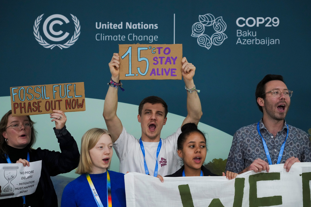 FILE - Activists participate in a demonstration for phasing out fossil fuels at the COP29 U.N. Climate Summit, Nov. 19, 2024, in Baku, Azerbaijan. (AP Photo/Sergei Grits, File)