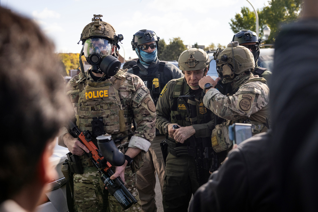 U.S. Border Patrol Commander-At-Large Gregory Bovino stands with federal immigration enforcement agents during a skirmish with protesters in Little Village neighborhood, Chicago Thursday, Oct. 23, 2025. (Ashlee Rezin/Chicago Sun-Times via AP)