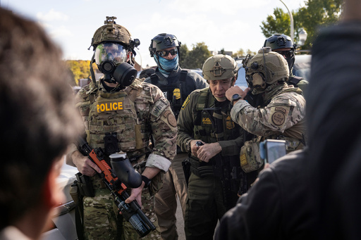 U.S. Border Patrol Commander-At-Large Gregory Bovino stands with federal immigration enforcement agents during a skirmish with protesters in Little Village neighborhood, Chicago Thursday, Oct. 23, 2025. (Ashlee Rezin/Chicago Sun-Times via AP) U.S. Border Patrol Commander-At-Large Gregory Bovino stands with federal immigration enforcement agents during a skirmish with protesters in Little Village neighborhood, Chicago Thursday, Oct. 23, 2025. (Ashlee Rezin/Chicago Sun-Times via AP)