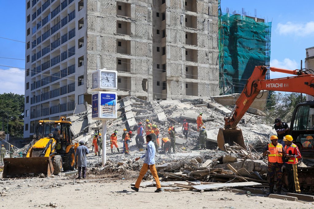 A rescue team works at the scene of a collapsed building in Nairobi, Kenya, Friday, Jan. 2, 2026. (AP Photo/Andrew Kasuku)