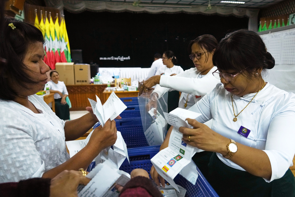 Officials of the Union Election Commission prepare to count votes at a polling station, during the first phase of general election, in Naypyitaw, Myanmar, Sunday, Dec. 28, 2025. (AP Photo/Aung Shine Oo)