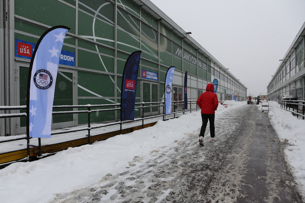 A person walks at the Cortina Olympic Village, ahead of the 2026 Winter Olympics, in Cortina d'Ampezzo, Italy, Tuesday, Feb. 3, 2026. (AP Photo/Jennifer McDermott)