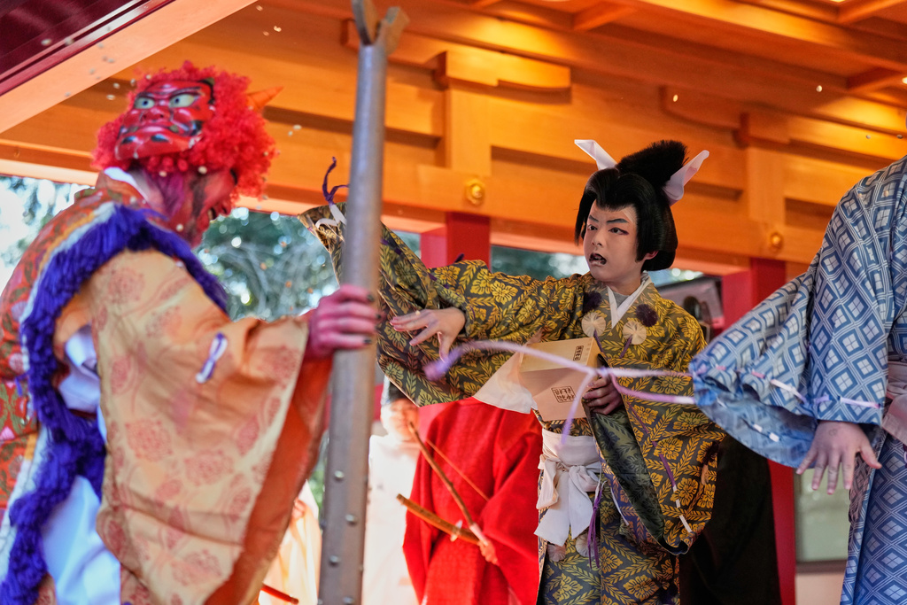 Lucky beans are thrown on an 'Oni', or demon-like figures in Japanese folklore, during the annual Bean Throwing Festival at Hakone Shrine in Hakone, Japan, Tuesday, Feb. 3, 2026. (AP Photo/Eugene Hoshiko)