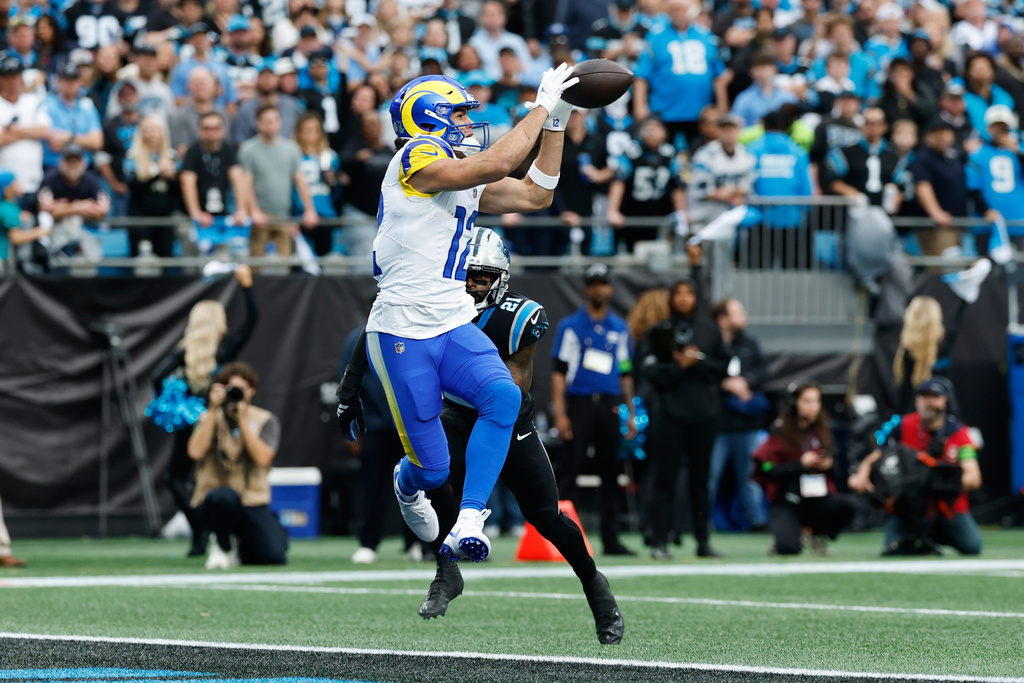 Los Angeles Rams wide receiver Puka Nacua (12) makes a touchdown catch past Carolina Panthers safety Nick Scott (21) during the first half of an NFL Wild Card playoff football game, Saturday, Jan. 10, 2026, in Charlotte, N.C. (AP Photo/Rusty Jones)