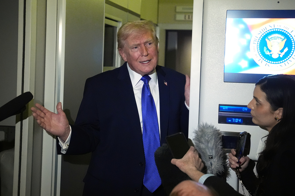 President Donald Trump speaks with reporters aboard Air Force One, Monday, Feb. 16, 2026, en route to Washington from West Palm Beach, Fla. (AP Photo/Matt Rourke)
