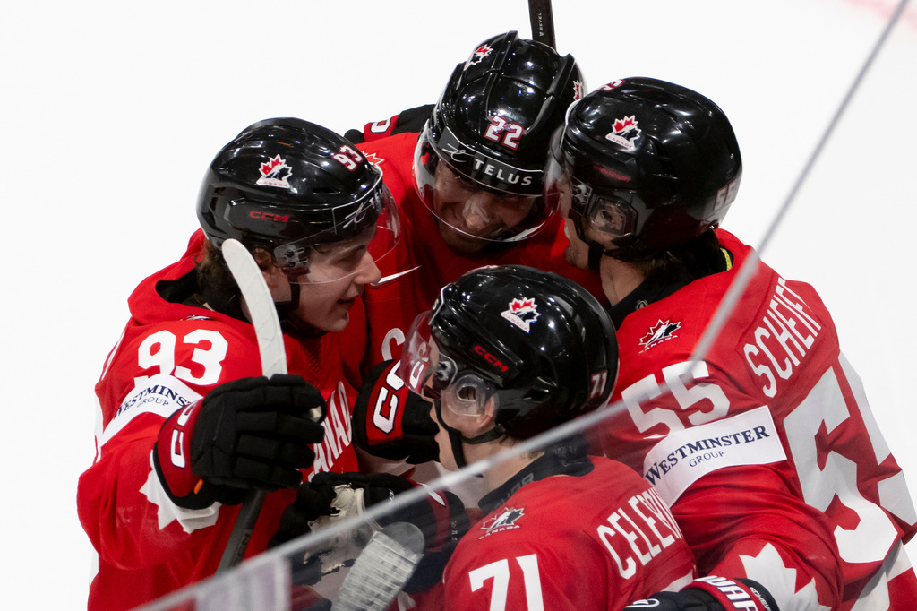 Canada's Mark Scheifele, right celebrates the winning goal in overtime with teammates, during the 2026 IIHF Men's Ice Hockey World Championship preliminary round group B game between Canada and Norway, in Fribourg, Switzerland, Thursday, May 21, 2026. (Anthony Anex/Keystone via AP)