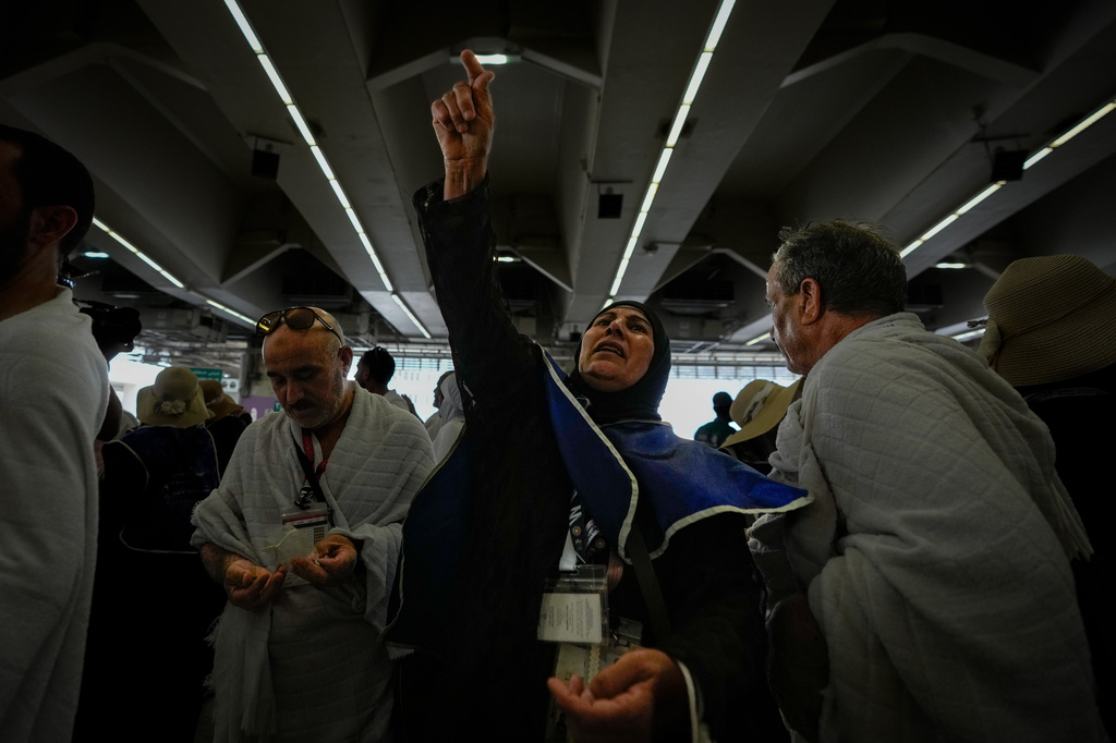 Muslim pilgrims cast pebbles at pillars in the symbolic stoning of the devil, the last rite of the annual Hajj, in Mina near the holy city of Mecca, Saudi Arabia, Wednesday, May 27, 2026. (AP Photo/Altaf Qadri)