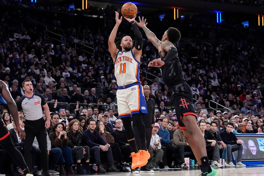New York Knicks guard Jalen Brunson (11) shoots over Houston Rockets forward Jabari Smith Jr. (10) during the second half of an NBA basketball game, Saturday, Feb. 21, 2026, in New York. (AP Photo/Yuki Iwamura)