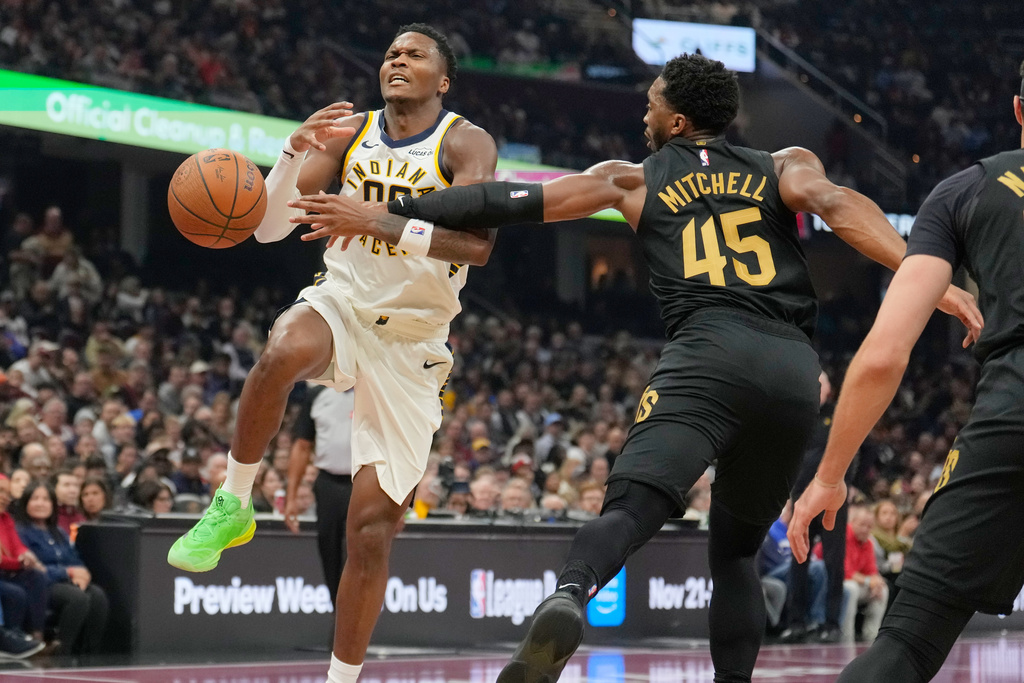 Indiana Pacers guard Bennedict Mathurin, left, is fouled by Cleveland Cavaliers guard Donovan Mitchell (45) in the first half of an NBA Cup basketball game Friday, Nov. 21, 2025, in Cleveland. (AP Photo/Sue Ogrocki)