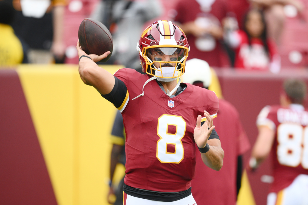 Washington Commanders quarterback Marcus Mariota (8) warms up before an NFL preseason football game against the Miami Dolphins, Friday, Aug. 14, 2026, in Landover, MD. (AP Photo/Nick Wass)