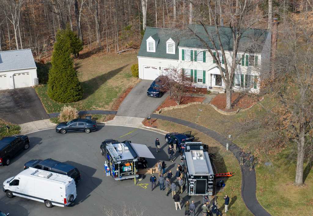 Prince William County Police block the street near the house where the FBI made an arrest, in Woodbridge, Va., Thursday, Dec. 4, 2025. (AP Photo/Steve Helber)