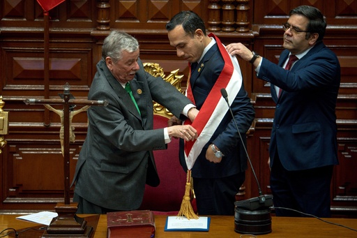 Peru's former president of the Congress Jose Jeri, center, receives the presidential sash from congressman Fernando Rospigliosi, left, as he is sworn-in as the interim president in Lima, Peru, Friday, Oct. 10, 2025. (AP Photo/John Reyes) Peru's former president of the Congress Jose Jeri, center, receives the presidential sash from congressman Fernando Rospigliosi, left, as he is sworn-in as the interim president in Lima, Peru, Friday, Oct. 10, 2025. (AP Photo/John Reyes)