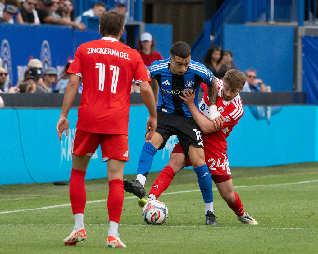 Chicago Fire FC's Jonathan Dean (24) and CF Montreal's Bryce Duke (10) battle for possession of the ball during the first half of an MLS soccer game in Montreal, Saturday May 16, 2026. (Peter McCabe/The Canadian Press via AP)