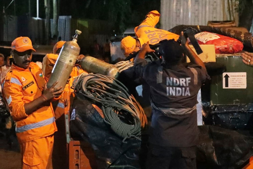 In this image provided by the Information and Public Relations Department, Government of Sikkim, National Disaster Response Force personnel prepare for a rescue operation at the site of an under-construction tunnel at a hydropower project in Samardung village, about 40 kilometers (25 miles) from Gangtok, India, late Monday, July 20, 2026. (Government of Sikkim via AP)