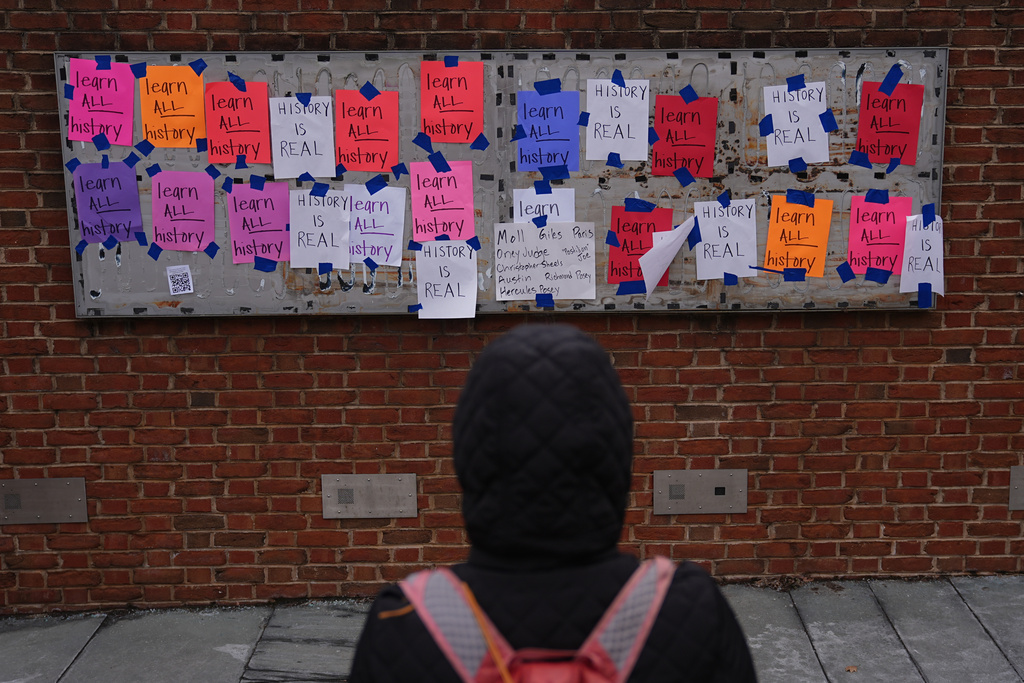 FILE - A person views posted signs on the locations of the now removed explanatory panels that were part of an exhibit on slavery at President's House Site in Philadelphia, Jan. 23, 2026. (AP Photo/Matt Rourke, file)