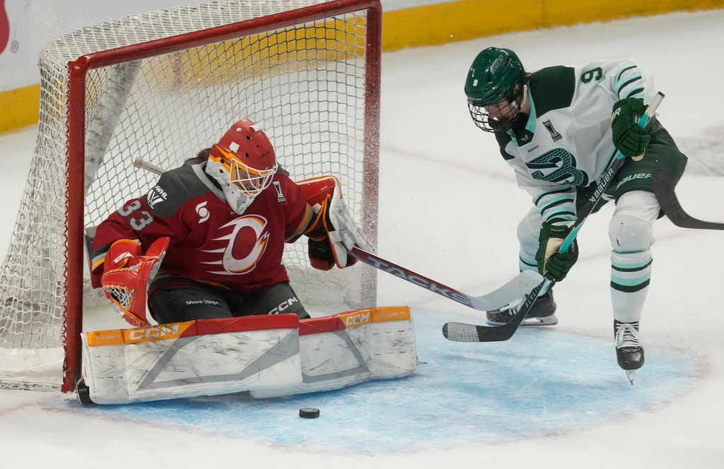 Boston Fleet forward Sophie Shirley (9) pressures Ottawa Charge goalie Gwyneth Philips (33) during the second period of Game 4 in a PWHL hockey playoff series in Ottawa, Ontario, Sunday, May 10, 2026. (Adrian Wyld/The Canadian Press via AP)