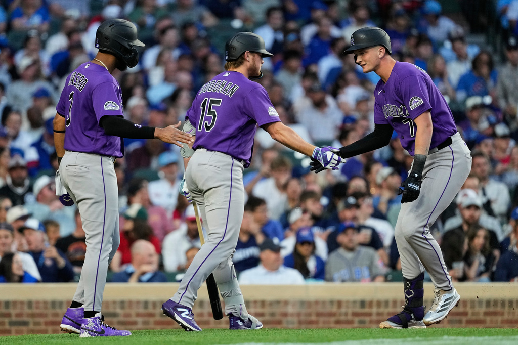 Colorado Rockies' TJ Rumfield, right, celebrates with Willi Castro, left, and Hunter Goodman after hitting a two-run home run during the fourth inning of a baseball game against the Chicago Cubs in Chicago, Tuesday, June 16, 2026. (AP Photo/Nam Y. Huh)