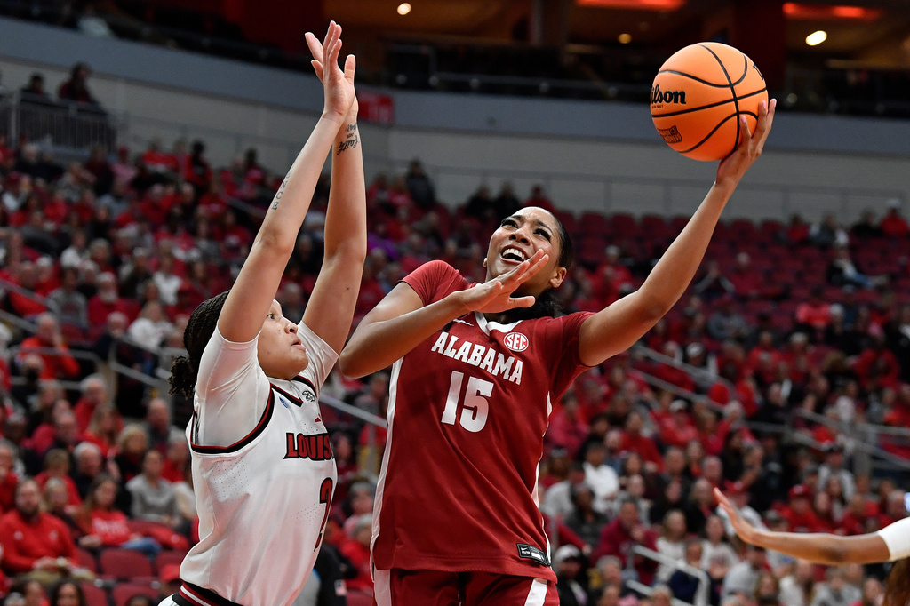 Alabama guard Ta'mia Scott (15) shoots over Louisville guard Imari Berry (2) during the first half in the second round of the NCAA college basketball tournament, Monday, March 23, 2026 in Louisville, Ky. (AP Photo/Timothy D. Easley)
