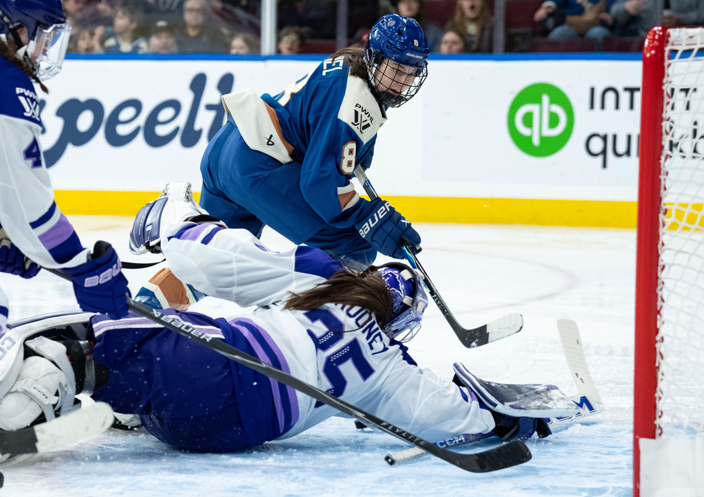 Minnesota Frost goaltender Maddie Rooney (35) stops Vancouver Goldeneyes' Izzy Daniel (8) during the third period of a PWHL hockey game in Vancouver, British Columbia, Saturday, March 21, 2026. (Ethan Cairns/The Canadian Press via AP)
