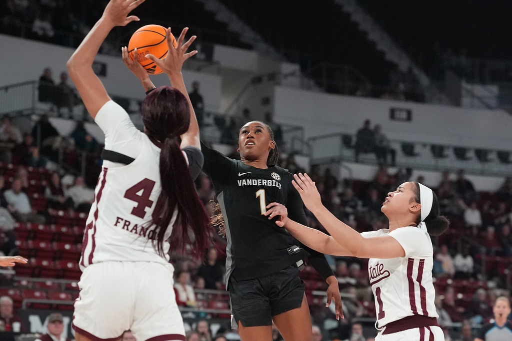 Vanderbilt guard Mikayla Blakes (1) is pressured by Mississippi State forward Madison Francis, left, and guard Saniyah King (1) as she attempts a layup during the first half of an NCAA college basketball game, Thursday, Jan. 15, 2026, in Starkville, Miss. (AP Photo/Rogelio V. Solis)
