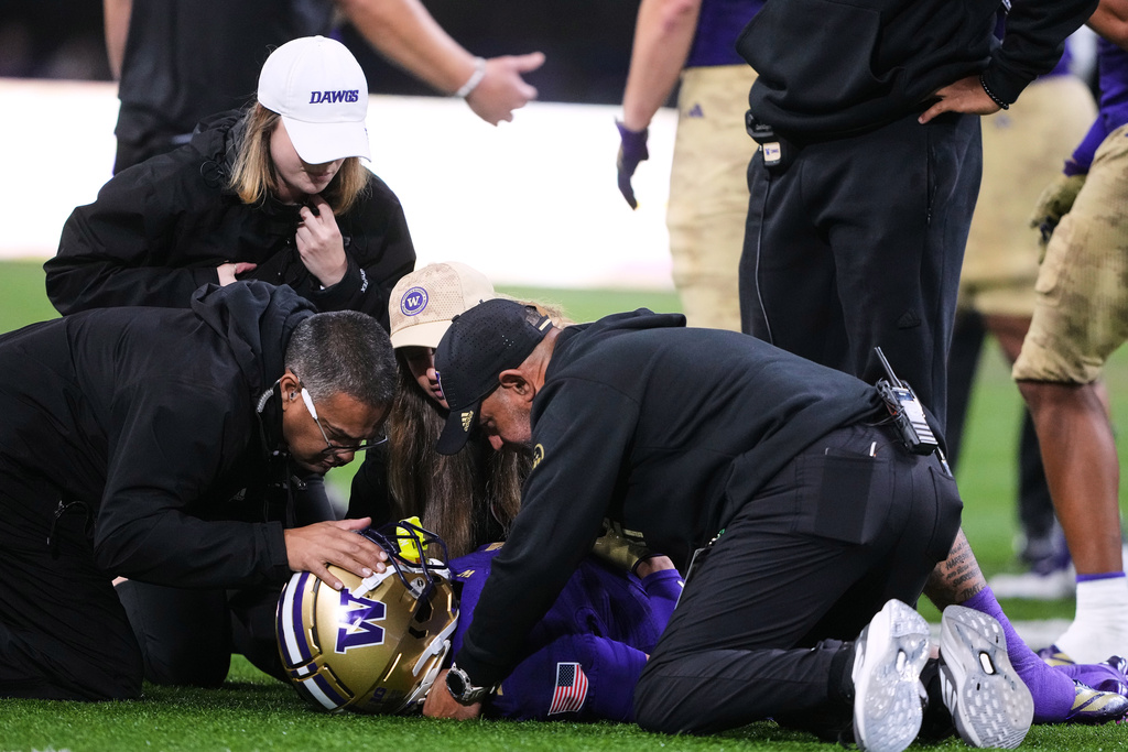Washington staff examine Washington wide receiver Raiden Vines-Bright after an injury on a play against Purdue during the first half of an NCAA college football game, Saturday, Nov. 15, 2025, in Seattle. (AP Photo/Lindsey Wasson)