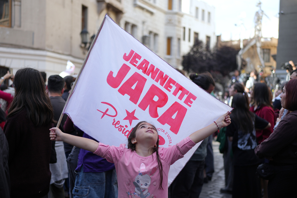 Supporters gather at the campaign headquarters of Jeannette Jara, presidential candidate of the ruling Unity for Chile coalition, after polls closed for the presidential runoff in Santiago, Chile, Sunday, Dec. 14, 2025. (AP Photo/Natacha Pisarenko)