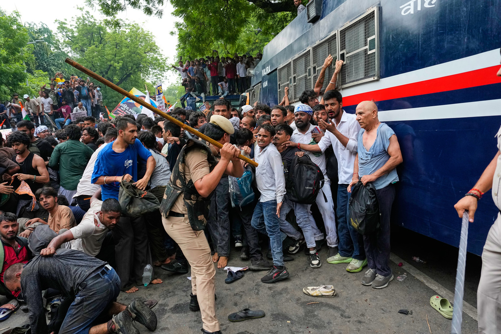 Police use batons to disperse supporters of the Cockroach Janta Party as they attempt to march toward India's Parliament, demanding the resignation of the education minister, in New Delhi, India, Monday, July 20, 2026. (AP Photo/Manish Swarup)