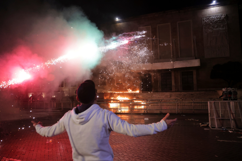 Protesters throw Molotov cocktails, flares and fireworks during an anti-government rally outside Prime Minister's office over corruption scandals and broader political issues, in Tirana, Albania, Tuesday, Feb. 10, 2026. (AP Photo/Hameraldi Agolli)
