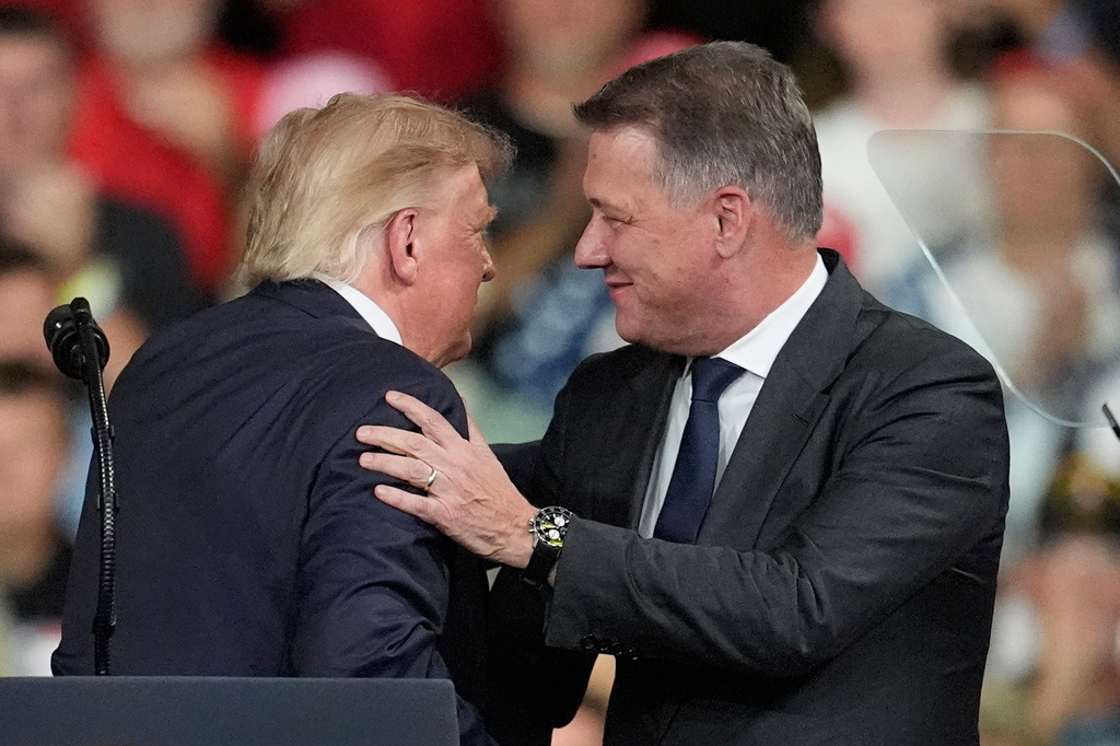 President Donald Trump greets Gernot D&ouml;llner, CEO of Audi AG, at a campaign rally at Guardian Centers of Georgia, Saturday, Oct. 24, 2026, in Perry, Ga. (A5P Photo/Mike Stewart)