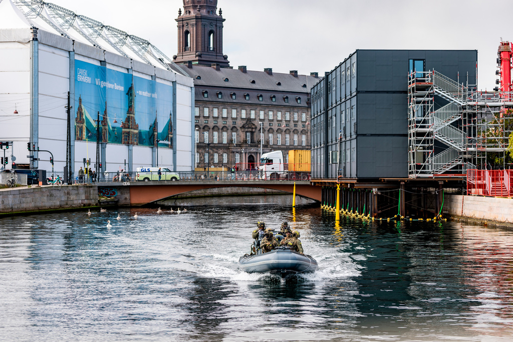Security on a dinghy boat around the Danish parliament at Christiansborg Castle in Copenhagen as Denmark is hosting an informal summit for the EUs heads of state and government, Wednesday, Oct. 1, 2025 . (Steven Knap/Ritzau Scanpix via AP)