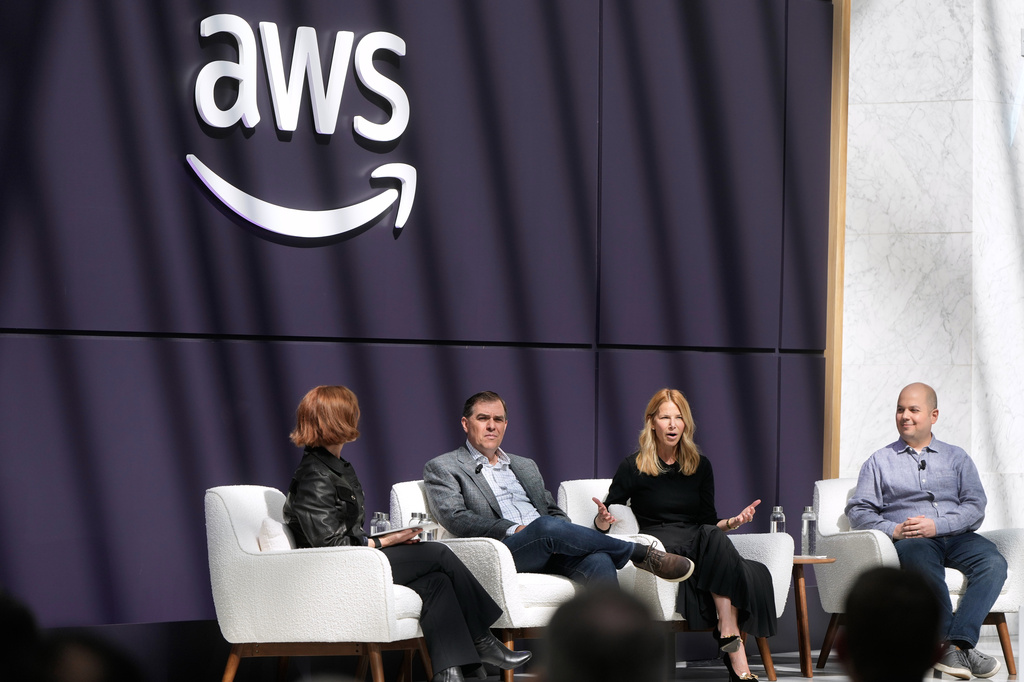 Denise Dresser, chief revenue officer of OpenAI, second right, speaks on stage with Julia White, vice president & chief marketing officer, AWS, from left, Matt Garman, CEO of AWS, and Anthony Liguori, vice president and distinguished engineer, AWS, at a What's Next with AWS event, Tuesday, April 28, 2026, in San Francisco. (AP Photo/Jeff Chiu)