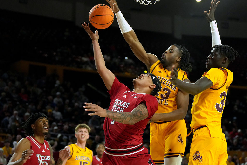 Texas Tech forward Lejuan Watts (3) drives past Arizona State forward Allen Mukeba (23) and center Massamba Diop during the first half of an NCAA college basketball game, Tuesday, Feb. 17, 2026, in Tempe, Ariz. (AP Photo/Rick Scuteri)