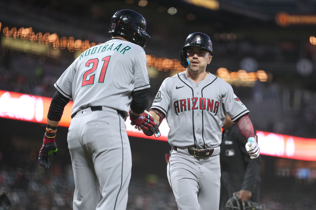 Arizona Diamondbacks' Corbin Carroll, right, is congratulated by teammate Lars Nootbaar (21) after hitting a two-run home run against the San Francisco Giants during the third inning of a baseball game in San Francisco, Friday, Aug. 28, 2026. (AP Photo/Tony Avelar)